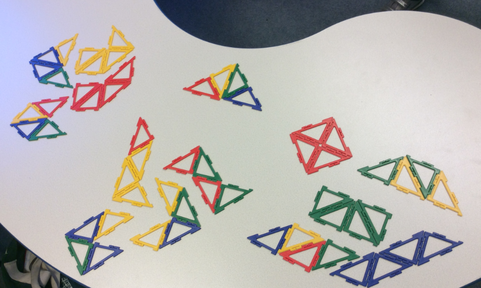 Photo of different arrangements of four triangles made with Polydron