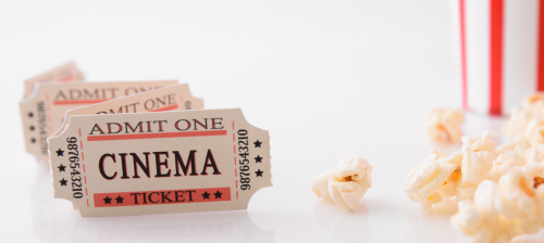 Some old-fashioned cinema tickets and spilt popcorn.