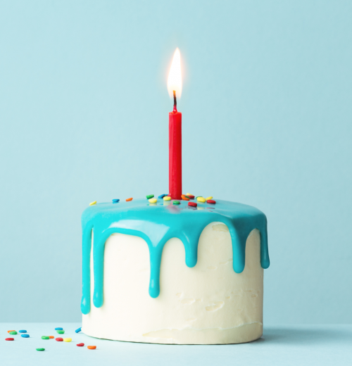 A birthday cake with blue icing and one red candle.