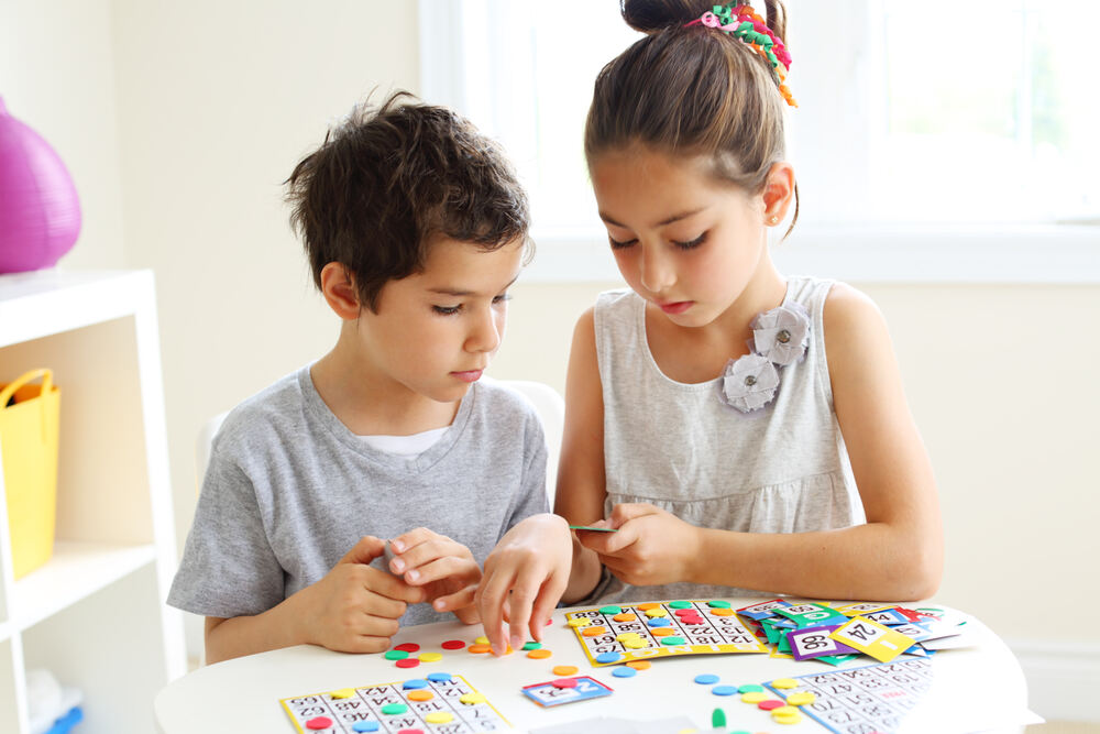 Young girl and boy working on a mathematics puzzle