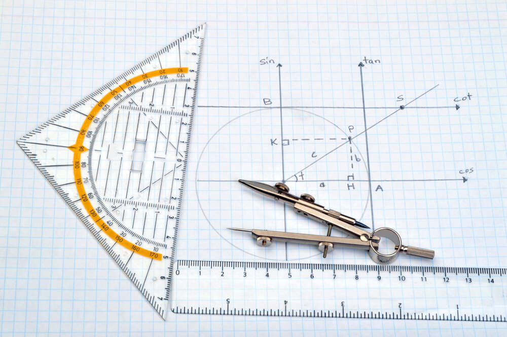 Protractor and set square on grid drawing paper