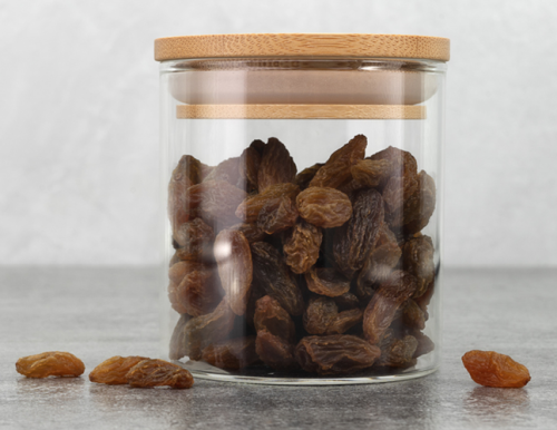 A glass jar of raisins.