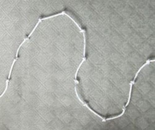 A piece of string knotted at equal intervals along the string to make 12 sections.