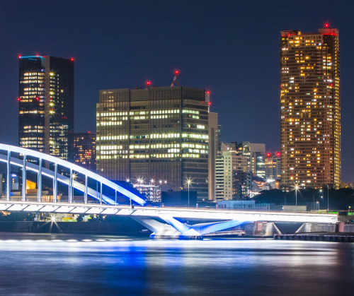 Skyscrapers with red lights on top of them.
