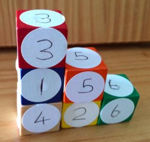 An arrangement of cubes with stacks of three, two and one cube pushed together to make a staircase.
