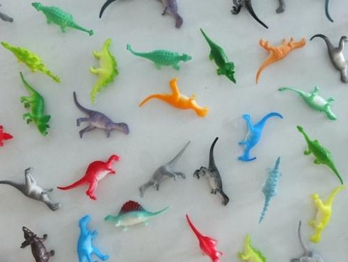A variety of plastic toy dinosaurs.