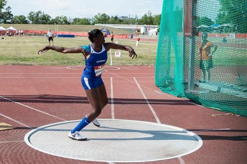 A woman throwing a discus in a sporting event.