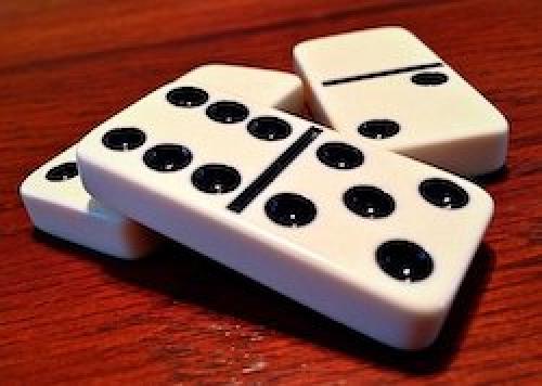Three dominoes on a table.