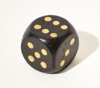 A black dice showing a 6.