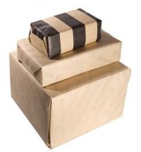 A stack of boxes of different sizes wrapped in brown paper.