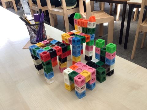 Two chairs and two tables made out of interlocking cubes