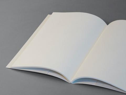 content-id-10989-Book%2520picture.jpg An open exercise book with blank pages, on a grey surface.