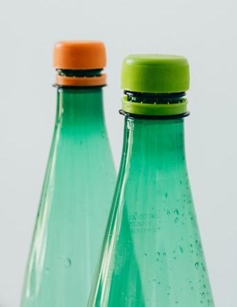 Number Rhymes The necks of two green bottles. One has an orange screw-on cap, and the other has a light green screw-on cap.