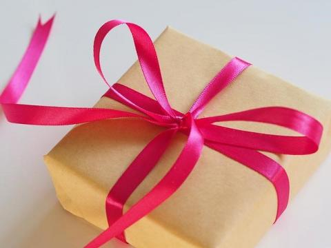 Presents A present wrapped in brown paper, with a pink ribbon tied over it in a bow.