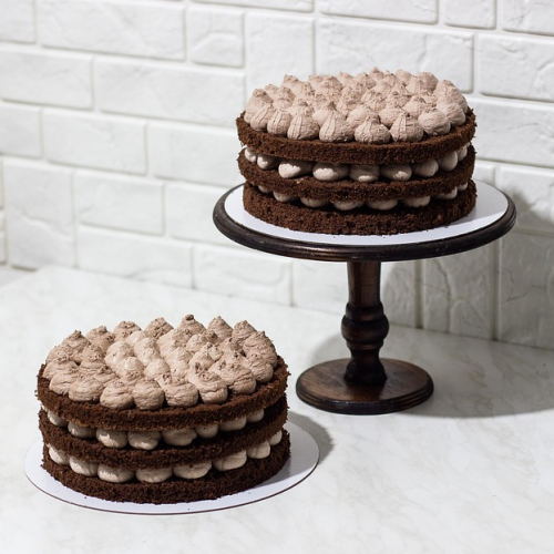 Two chocolate cakes with chocolate icing.
