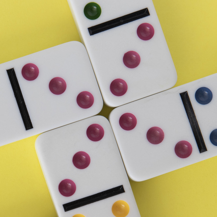 Four dominoes arranged with four threes in the centre.