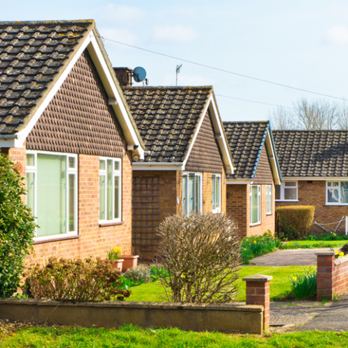 A row of bungalows with triangular roofs.
