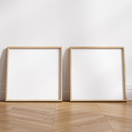 Two blank square picture frames on a wooden floor.