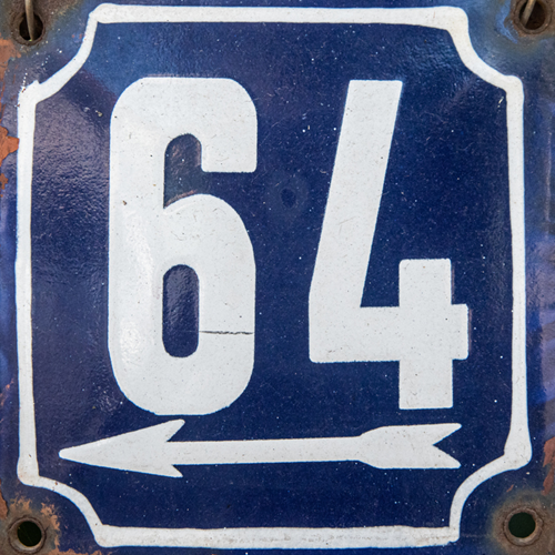 The number 64 and an arrow on a blue metal plate.