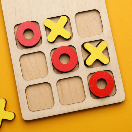 A wooden game of noughts and crosses.