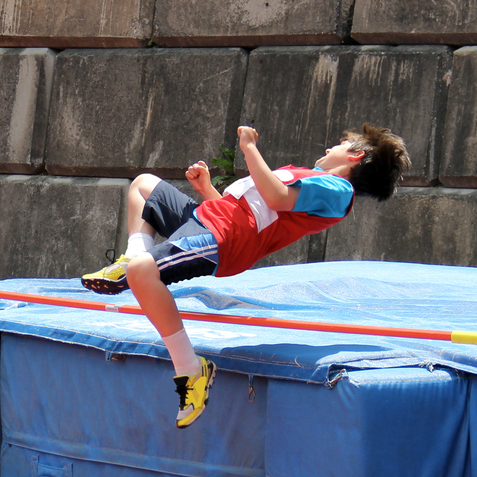A boy doing the high jump.