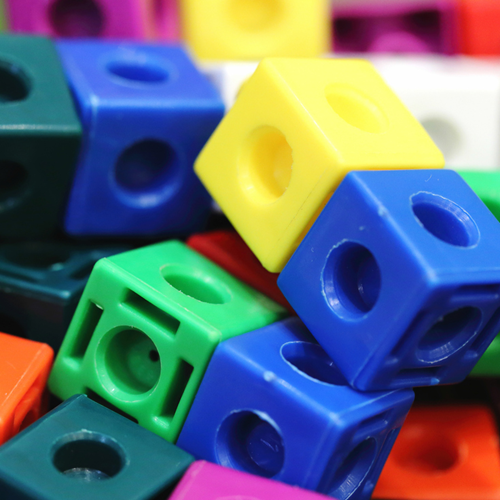 A pile of colourful plastic multilink cubes.