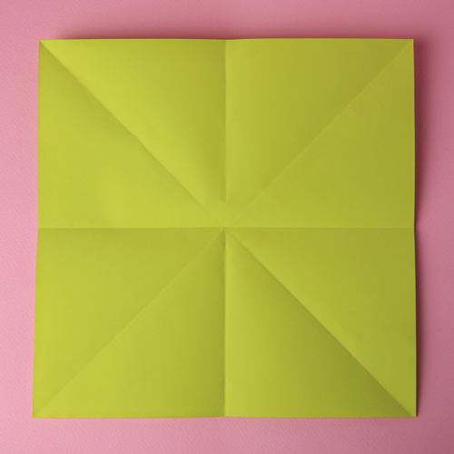 An origami square with crease lines.