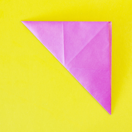 A piece of origami paper folded into a triangle.