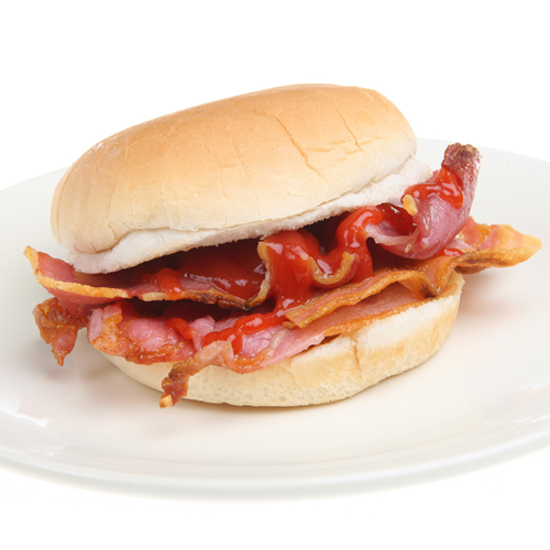 A bacon roll on a plate.
