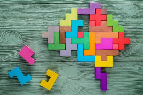 A 2D model of the brain made from coloured puzzle pieces.