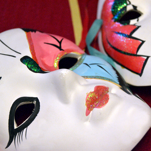 Two painted carnival masks.