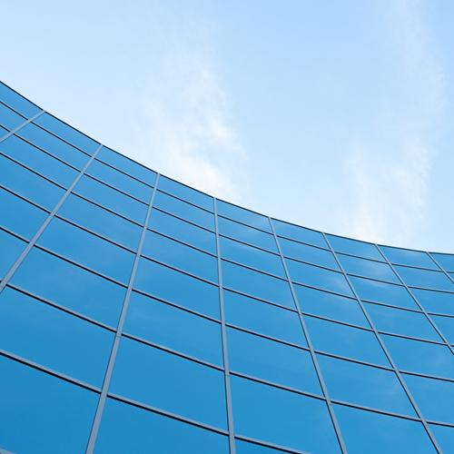 A skyscraper with curved glass windows.