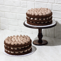 Two chocolate cakes with chocolate icing.