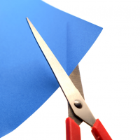 A pair of scissors about to cut the corner of a blue piece of paper.