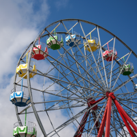A ferris wheel with colourful compartments.