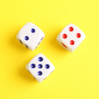 Three white dice on a yellow background.