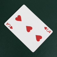 The three of hearts playing card on a green background.
