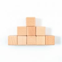 Wooden cubes arranged in rows of one, three and five.