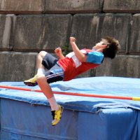 A boy doing the high jump.